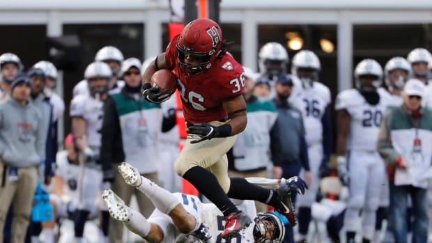 Nov 17, 2018; Boston, MA, USA; Harvard running back Devin Darrington (36) runs over Yale defensive back Rodney Thomas II (26) during the second half at Fenway Park.